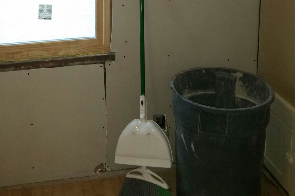 Garbage can with broom and dustpan