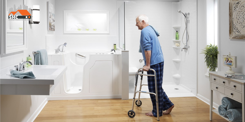 An Old Man walking towards his accessible bathtub